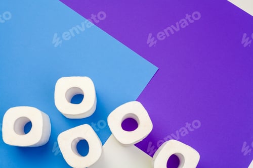 Preview: Rolls of toilet paper on color background, top view. creative photo