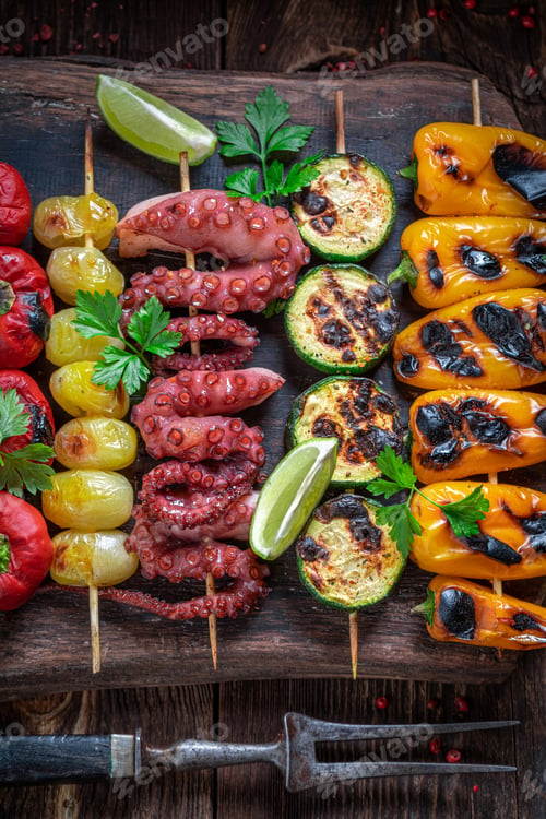 Preview: Hot roasted skewer cooking on grill with metal grate.