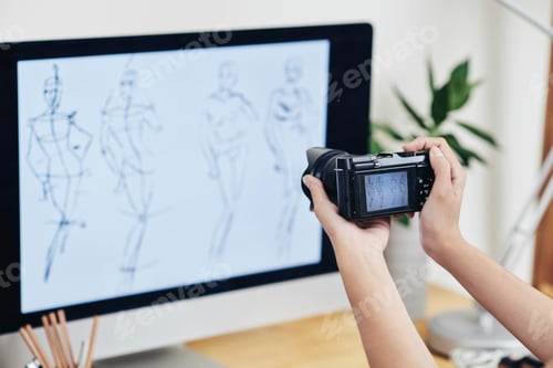 Preview: designer photographing computer screen