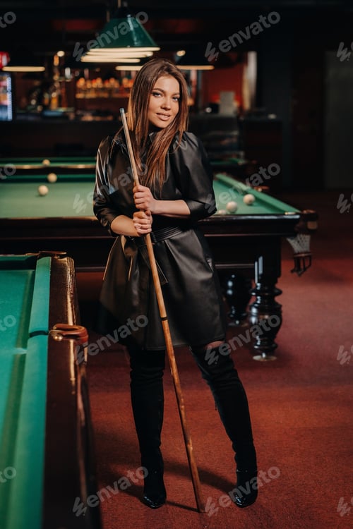 Preview: A girl with a cue in her hands is standing in a billiard club.Russian billiards