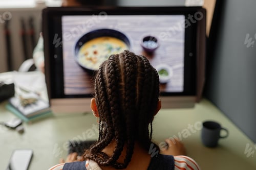 Preview: Back View of Black Woman Editing Pictures