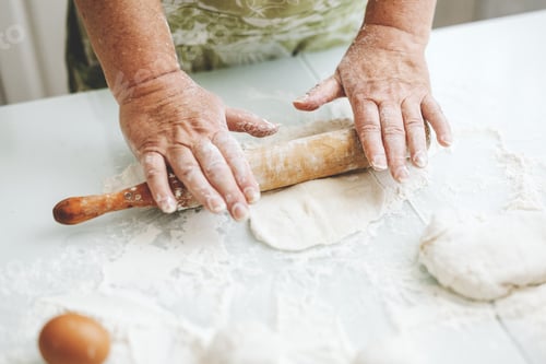Preview: Woman kneading dough at home kitchen