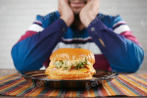 Preview: hungry man waiting for eating beef burger on table close up
