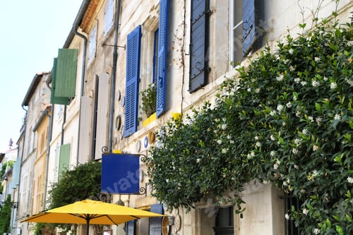 Preview: Street in France Europe with colorful shutters, flowers and umbrella