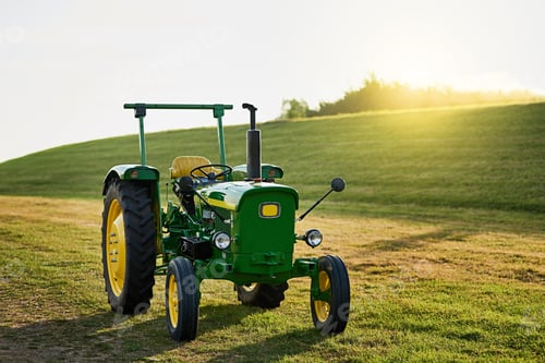Preview: Ready for a good plowing. Shot of a tractor on an open piece of land.