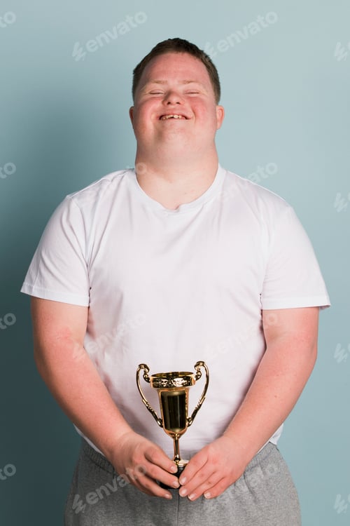 Preview: Cute boy with down syndrome holding a trophy