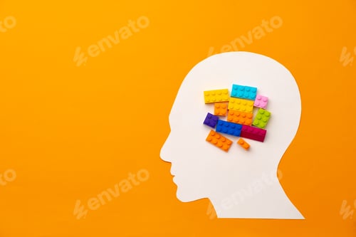 Preview: Papercut head silhouette with toy constructor pieces on yellow background