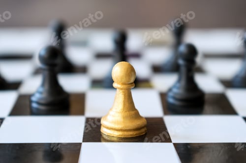 Preview: Leading main gold pawn stands ahead of other ordinary pawns in chess game on black and white