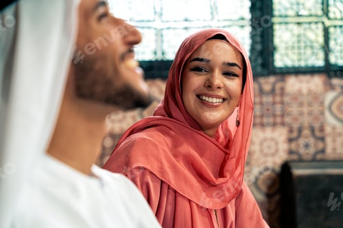 Preview: Young couple from Emirati spending time in a cafe