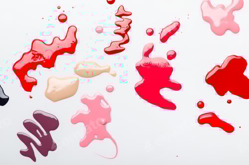 Preview: top view of bright multicolored spills of nail polish isolated on grey