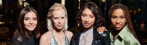 Preview: group portrait of stylish multiethnic girlfriends looking at camera in bar, horizontal banner