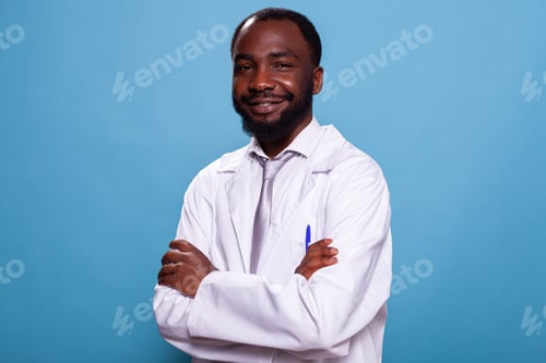 Preview: Portrait of smiling african american doctor posing with arms crossed