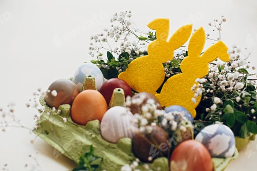 Preview: Natural dyed easter eggs and rabbit decorations on wooden background
