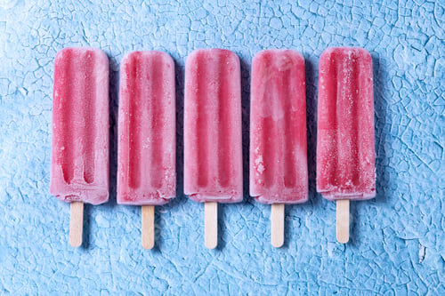 Preview: Strawberry popsicles on blue background
