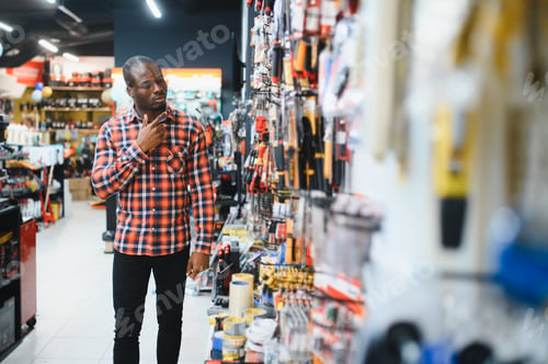 Preview: An African American man chooses tools in a hardware store