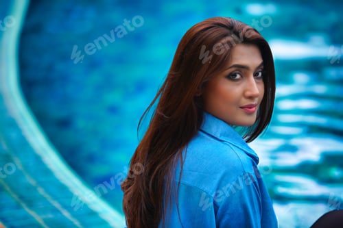 Preview: Portrait of beautiful model near the pool