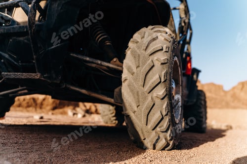 Preview: Close-up view of an ATV wheel. ATV in the desert, entertainment.