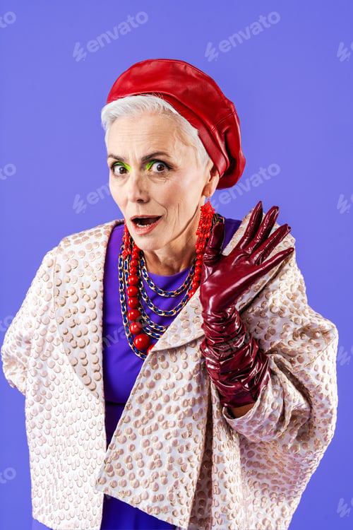 Preview: Happy and funny senior old woman on colorful background