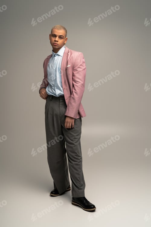 Preview: Handsome stylish man showcasing modern fashion in a chic studio setting