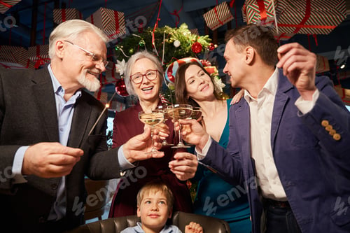 Preview: Family at New Year party holding Christmas sparklers and enjoying champagne