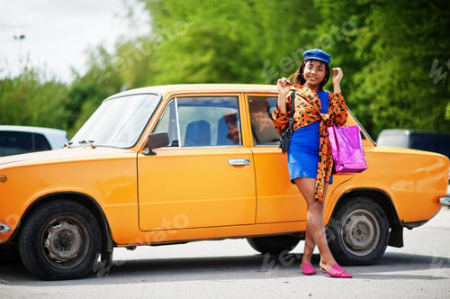 Preview: African american lady near orange classic retro car