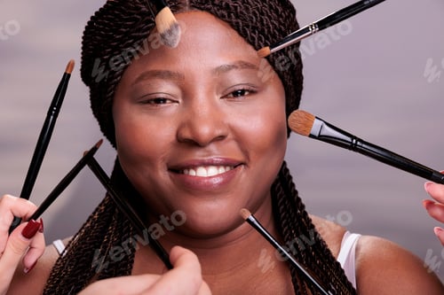Preview: Makeup artist hands applying decorative cosmetics on woman face