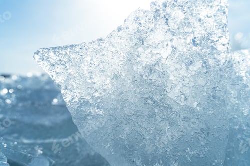 Preview: Closeup of transparent shining clear ice pieces sparkling from the sunlight