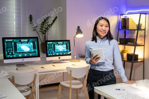 Preview: Portrait of attractive Asian car designer in office