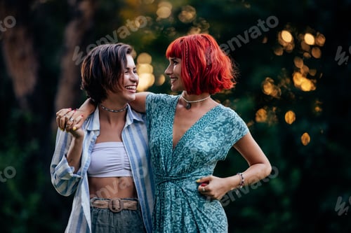 Preview: Beautiful female couple, lovely looking at each other, enjoying the outdoor.