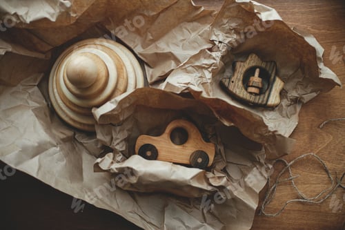 Preview: Stylish wooden toys for child on craft paper on wooden table, flat lay. Eco friendly plastic free