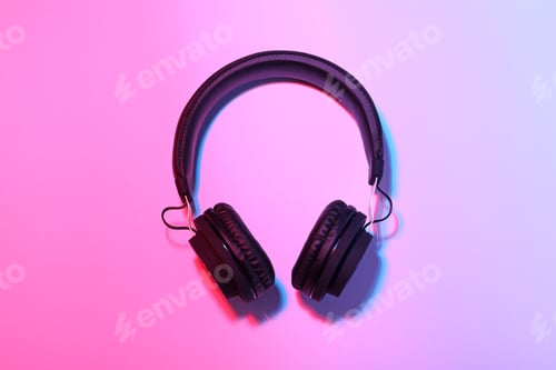 Preview: Stylish headphones on color background, top view