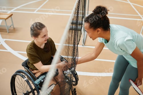 Preview: Two Women Shaking Hands Across a Badminton Net