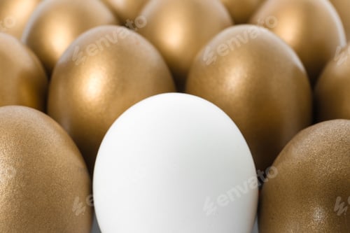 Preview: Golden eggs with different one as background, closeup