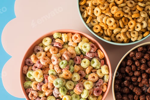 Preview: Different types of breakfast cereal. Chocolate balls, round cereals and colourful rings.