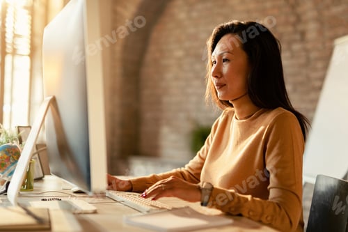 Preview: Asian businesswoman working on a computer in the office.