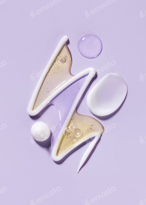 Preview: cosmetic smear of white creamy texture with drops of serum on pastel background close-up