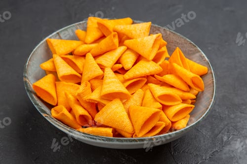 Preview: Top view of delicious snacks in a blue bowl on a dark background