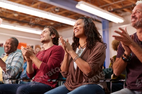 Preview: Group Attending Neighborhood Meeting In Community Center Clapping