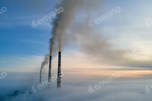 Preview: Aerial view of coal power plant high pipes with black smoke moving up polluting atmosphere at sunset