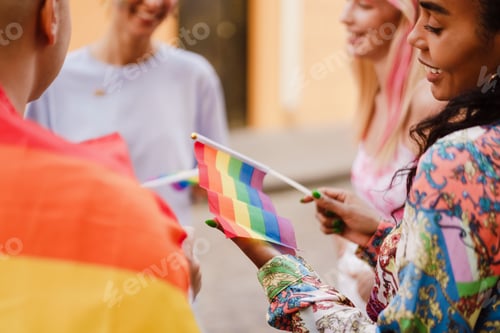 Preview: Man and women talking and holding rainbow flag during pride parade