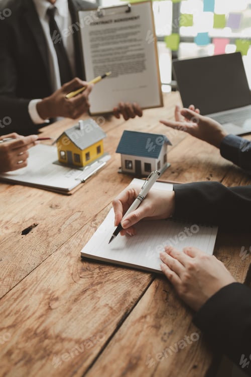 Preview: Real Estate Team Meeting Discussing Contracts at Office