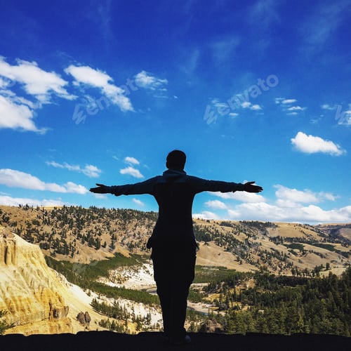 Person Standing on Cliff Overlooking Grand Canyon