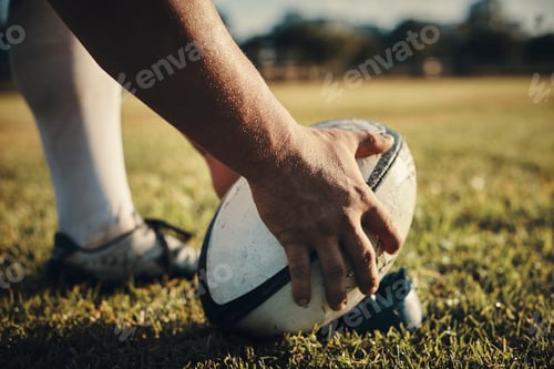Preview: Cropped shot of an unrecognizable rugby player preparing for a kick on the field during the day