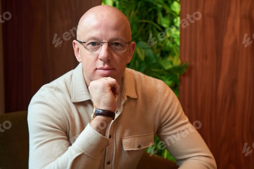 Preview: Middle-aged man sits in room witha living panel