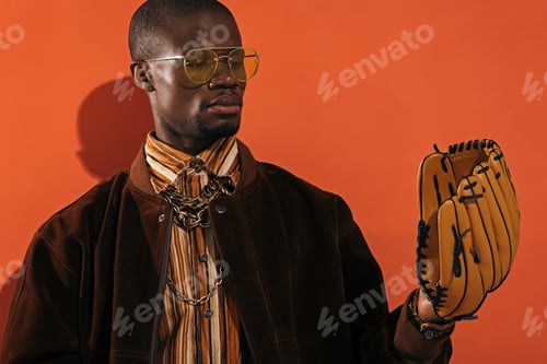 Preview: serious stylish african american man in sunglasses holding baseball glove
