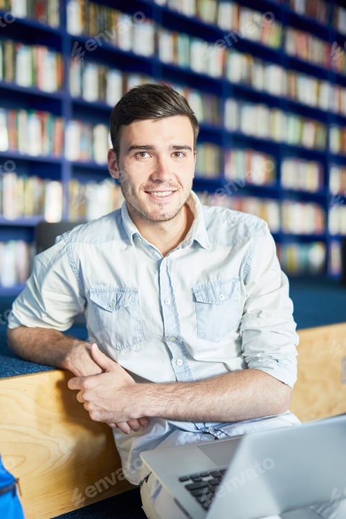 Man with laptop at library