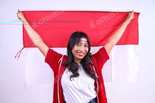 Preview: Woman Smiling Holding Red and White Flag Indoors