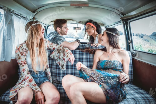 Preview: Happy friends driving a vintage minivan