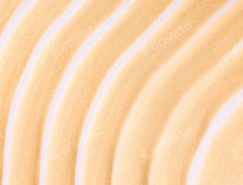 Preview: creamy cosmetic texture of golden shining color cosmetic smear on beige background close-up
