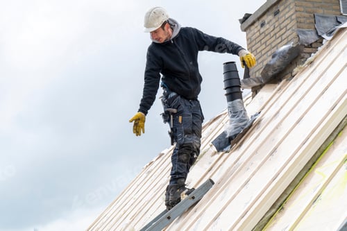 Preview: Portrait of tradesman on a roof wearing safety gear and hard hat